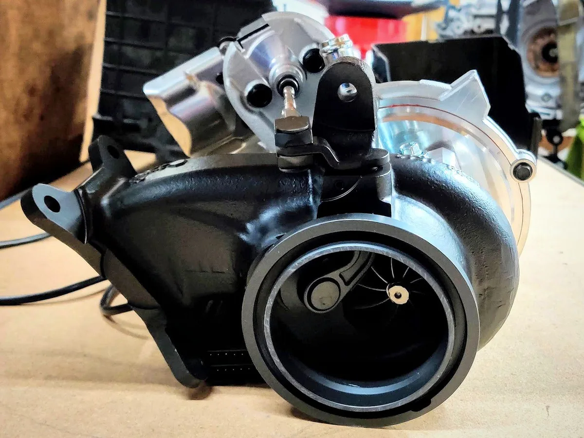 A rebuilt turbocharger sitting on the workbench