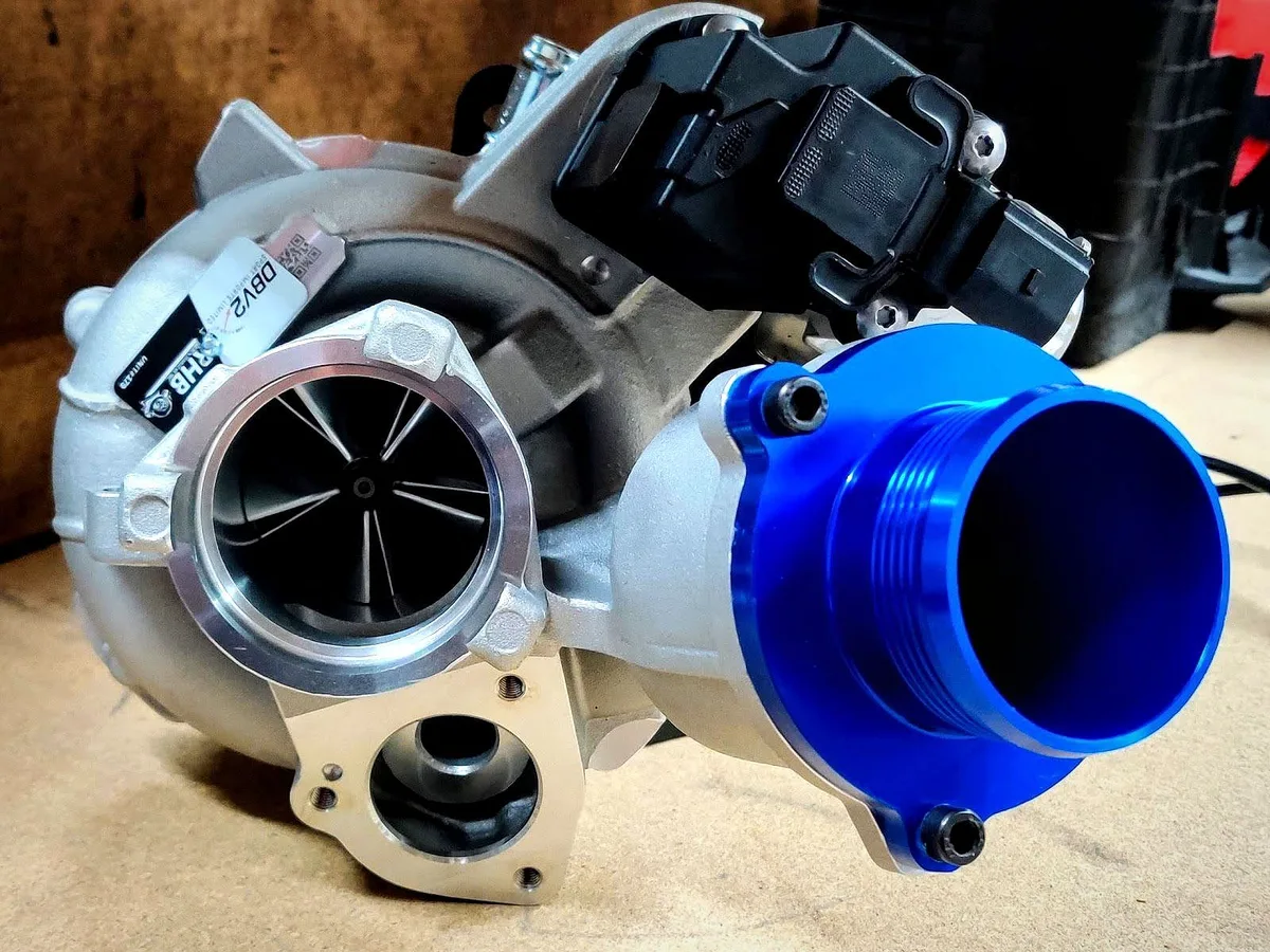 A turbocharger with a blue billet inlet, fresh on the bench